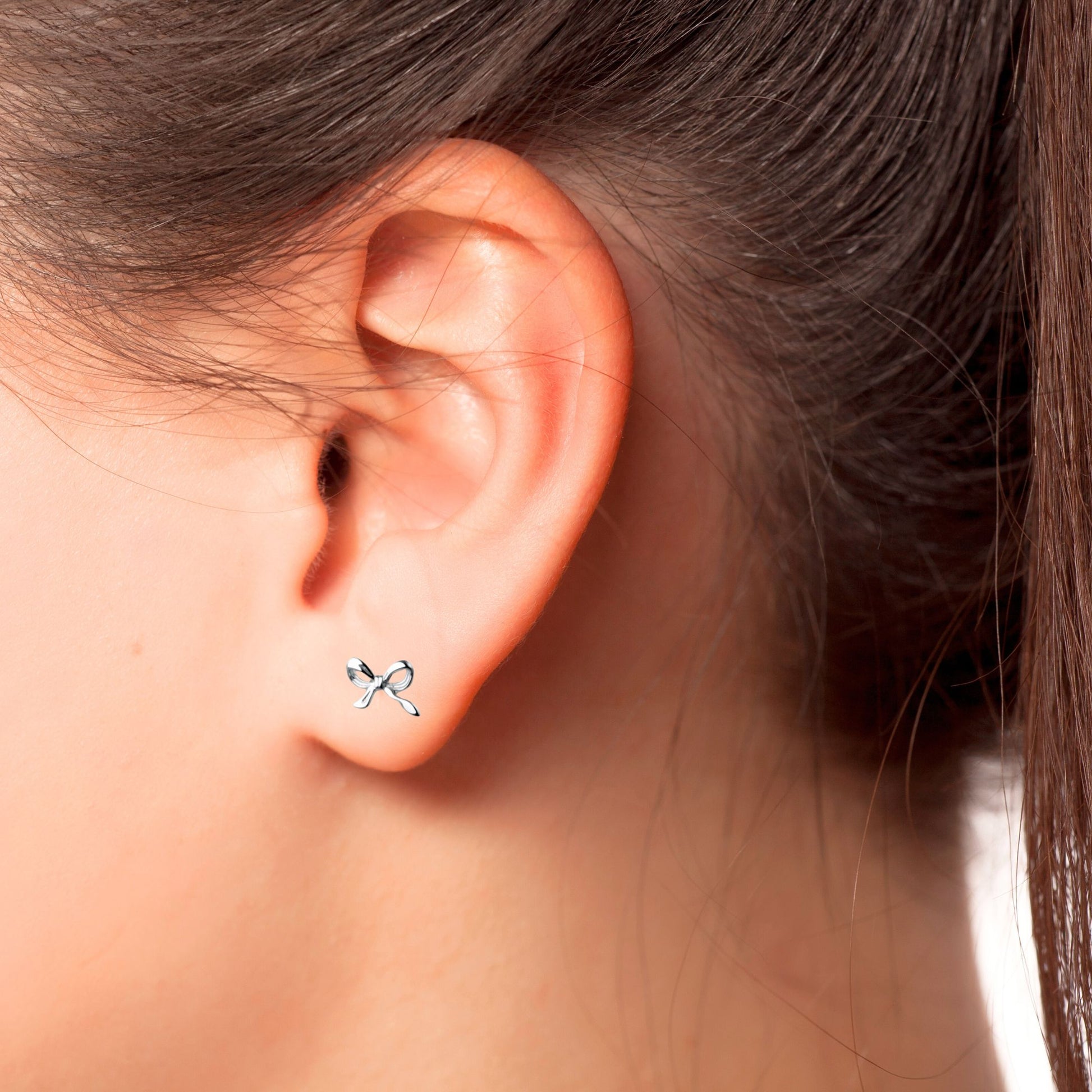 Wearing the Petite Bow Studs in Sterling Silver 925 metal